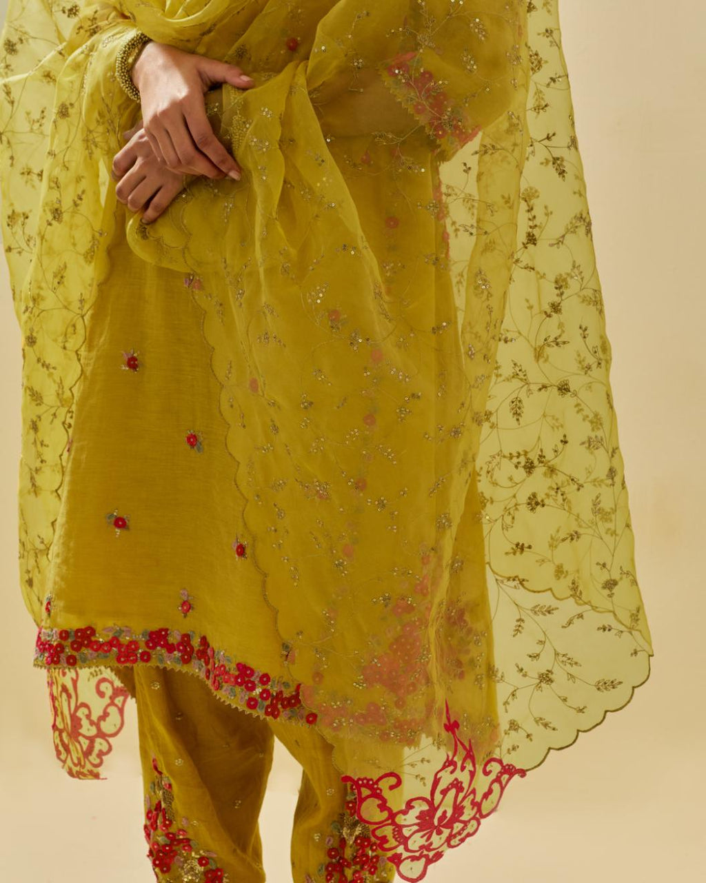 Yellow tissue chanderi mid length kalidar kurta set with hand cut silk flower embroidery, highlighted with gold sequins.