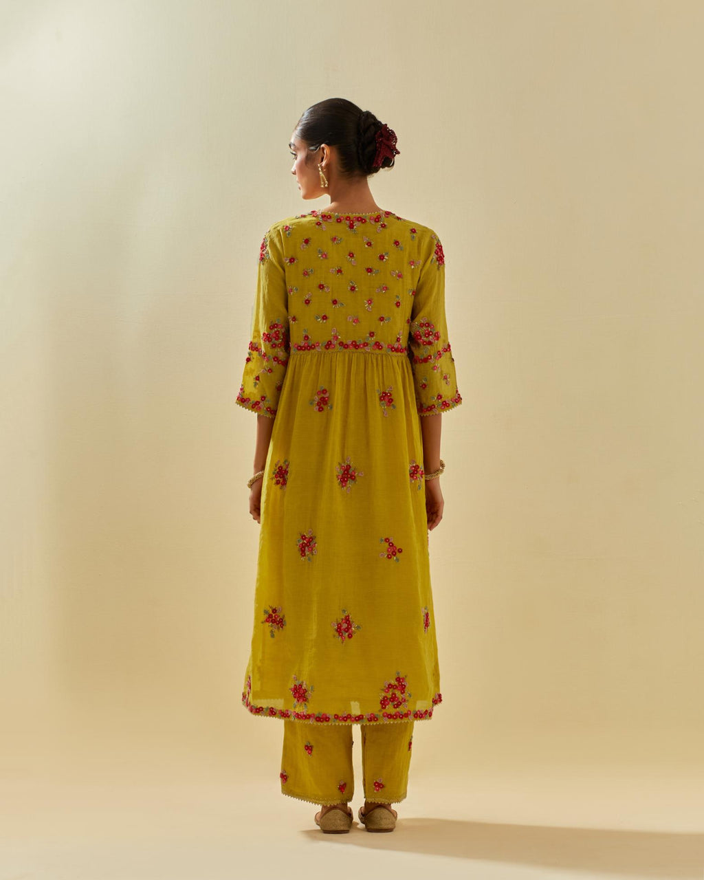 Yellow tissue chanderi hand cut silk flower embroidered kurta dress set with fine gathers at empire line.