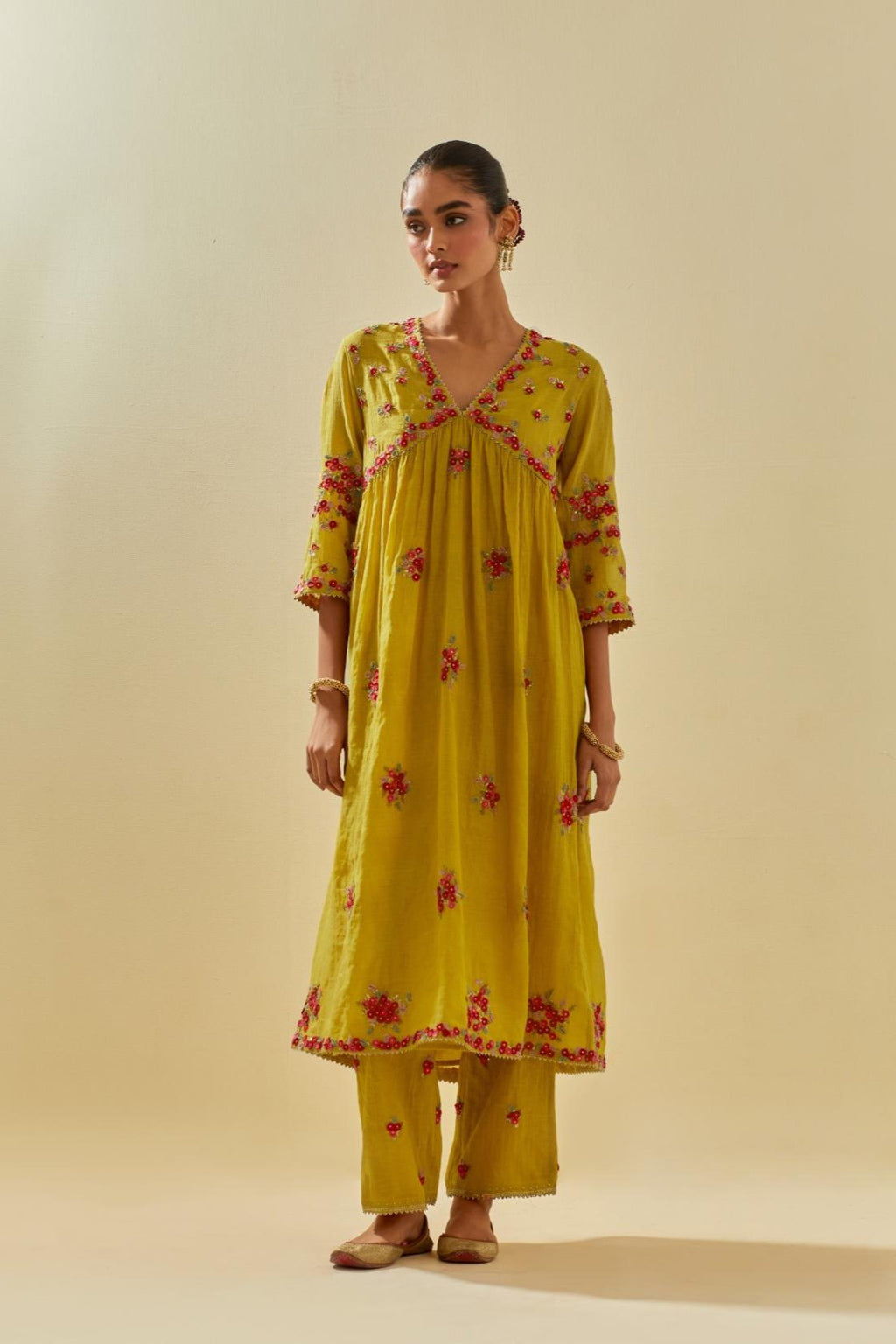 Yellow tissue chanderi hand cut silk flower embroidered kurta dress set with fine gathers at empire line.