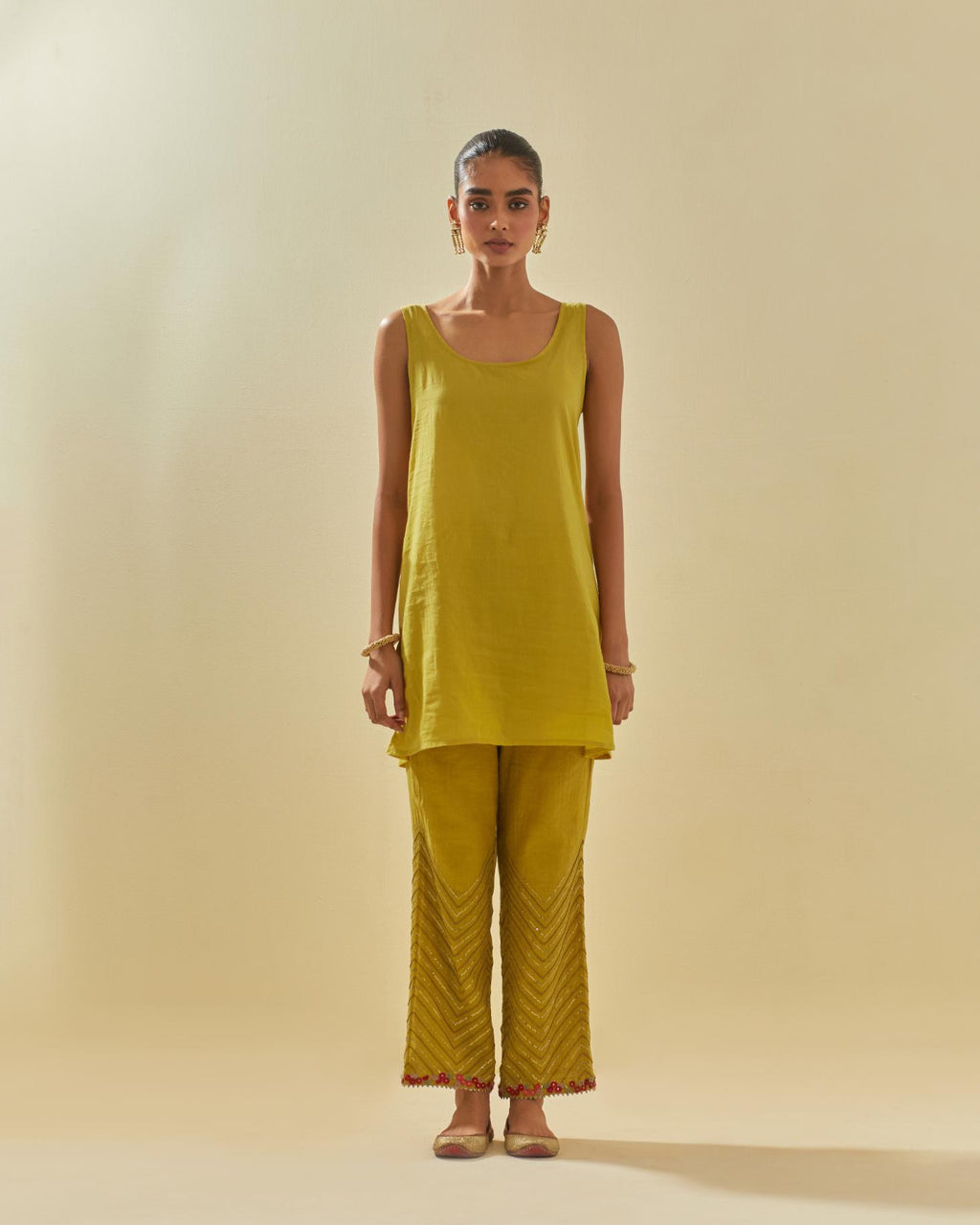 Yellow tissue chanderi easy fit short kurta set, highlighted with gold sequins and beads.