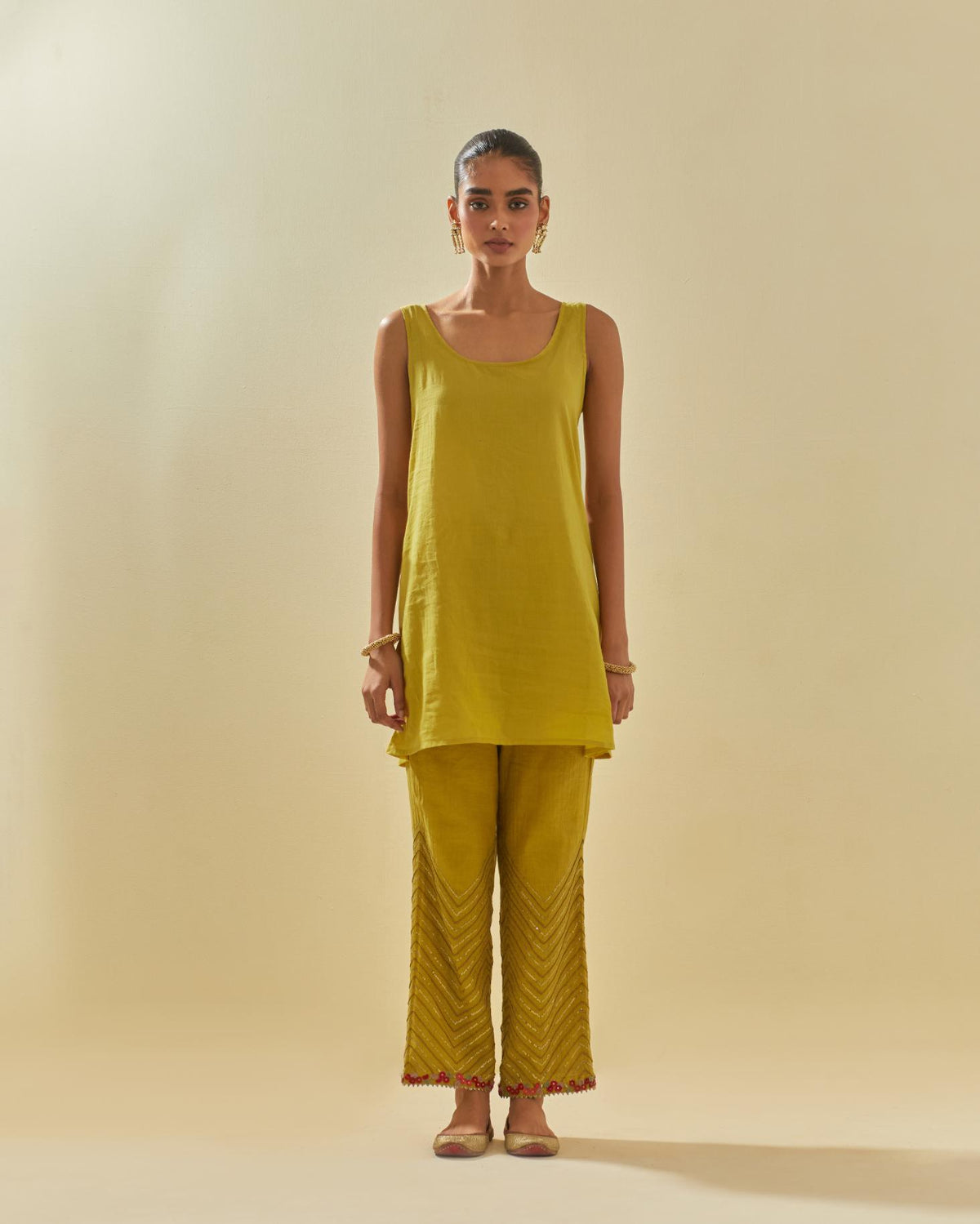 Yellow tissue chanderi easy fit short kurta set, highlighted with gold sequins and beads.