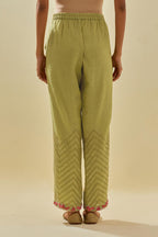 Green tissue chanderi straight pants with hand cut silk flower embroidery at hem, highlighted with gold sequins and beads.