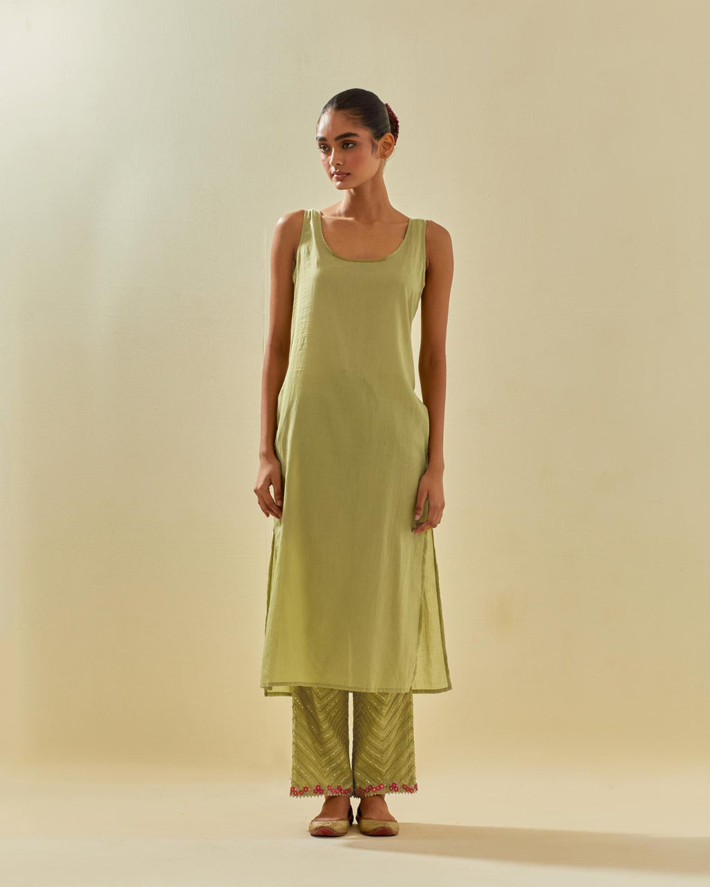 Green tissue chanderi straight kurta set with delicate hand cut silk flower embroidery, highlighted with gold sequins and beads.