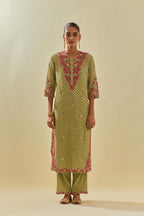 Green tissue chanderi straight kurta set with delicate hand cut silk flower embroidery, highlighted with gold sequins and beads.