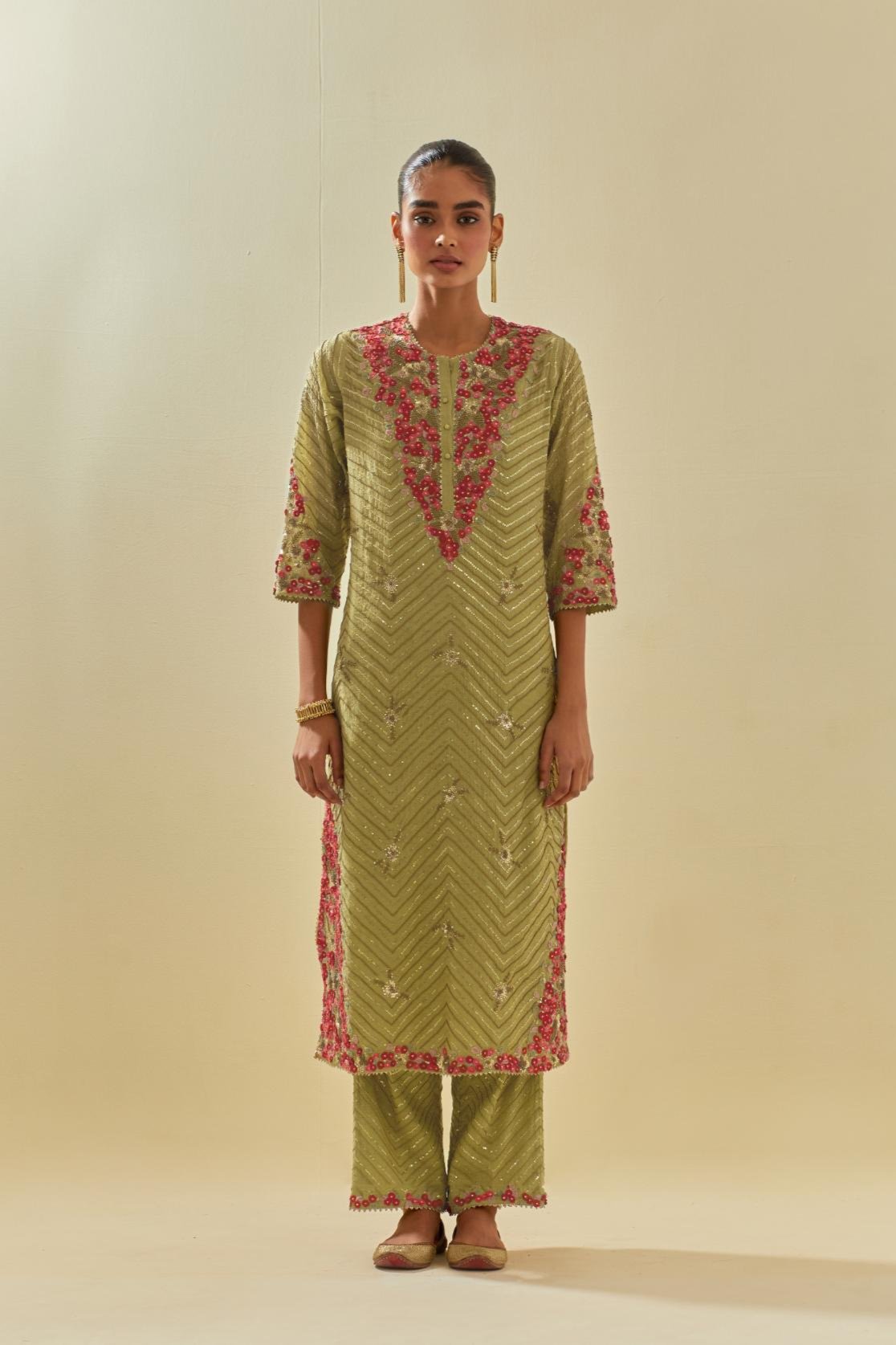 Green tissue chanderi straight kurta set with delicate hand cut silk flower embroidery, highlighted with gold sequins and beads.