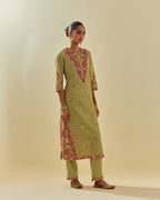 Green tissue chanderi straight kurta set with delicate hand cut silk flower embroidery, highlighted with gold sequins and beads.