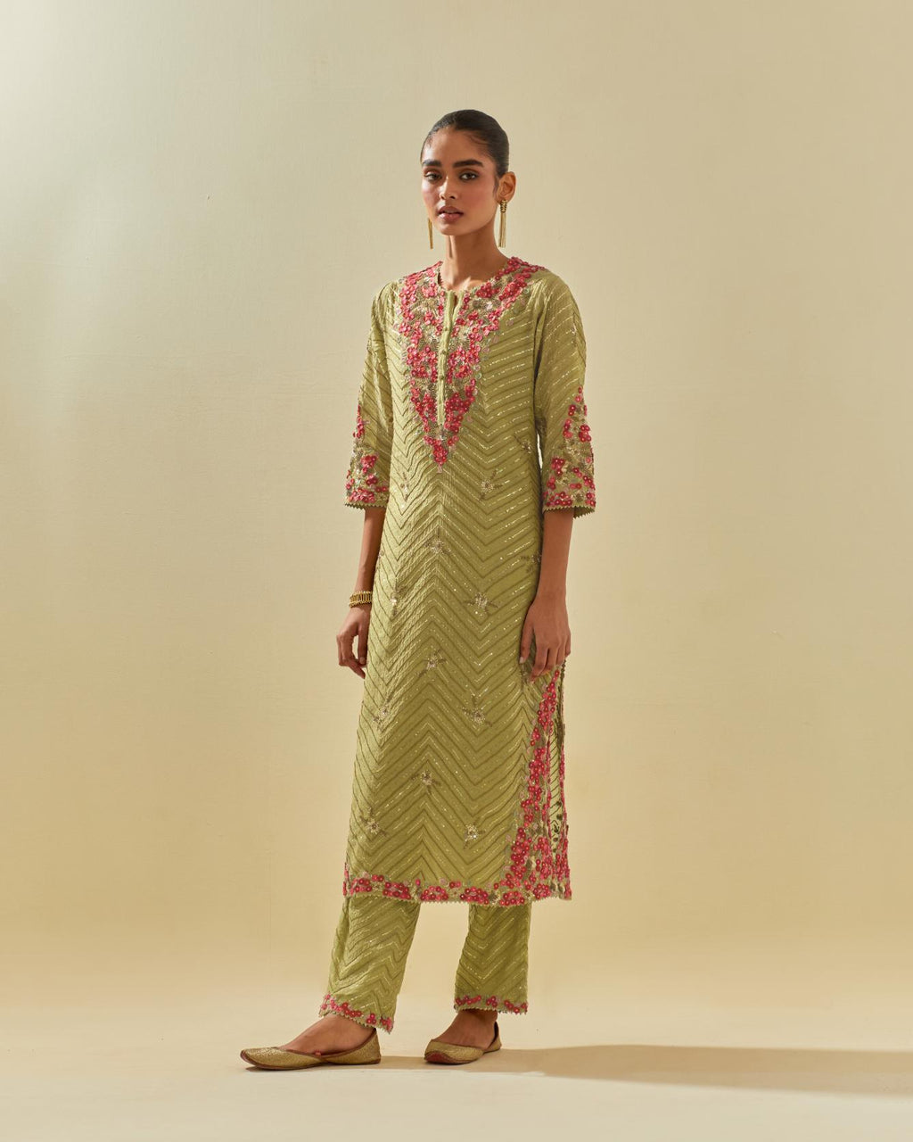 Green tissue chanderi straight kurta set with delicate hand cut silk flower embroidery, highlighted with gold sequins and beads.
