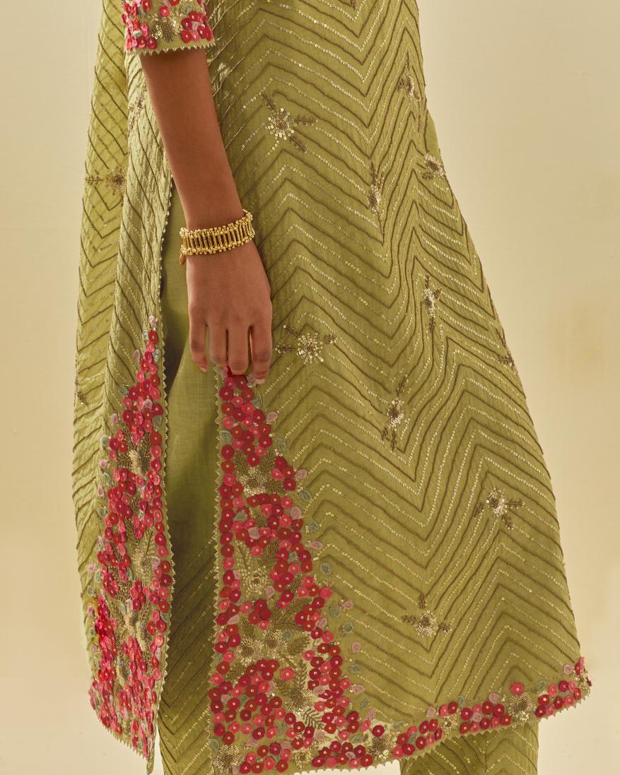 Green tissue chanderi straight kurta set with delicate hand cut silk flower embroidery, highlighted with gold sequins and beads.