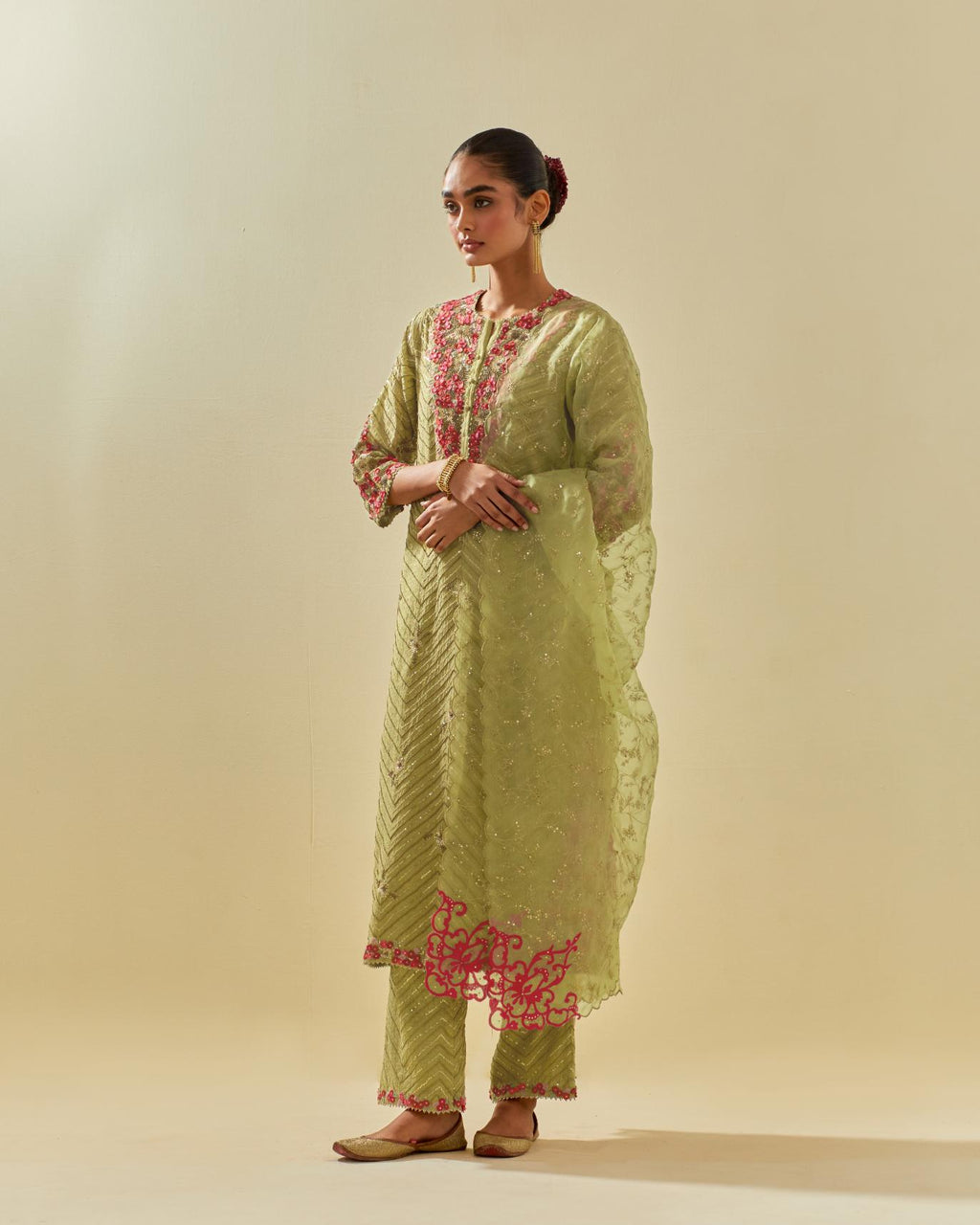 Green tissue chanderi straight kurta set with delicate hand cut silk flower embroidery, highlighted with gold sequins and beads.