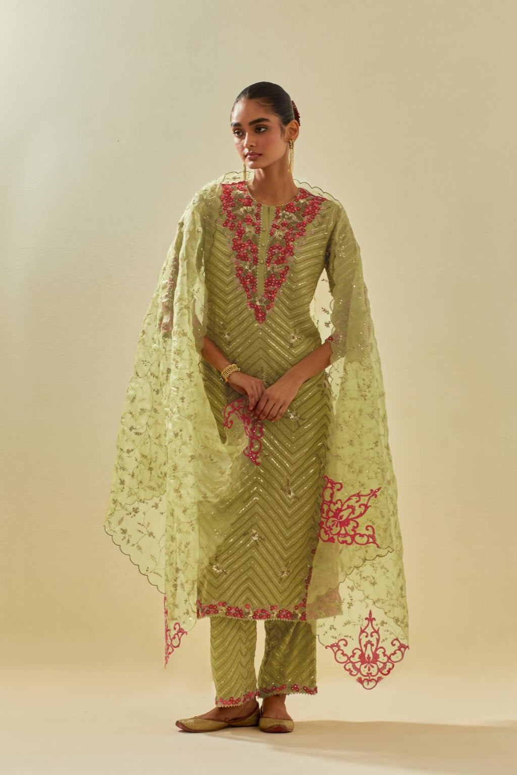 Green tissue chanderi straight kurta set with delicate hand cut silk flower embroidery, highlighted with gold sequins and beads.