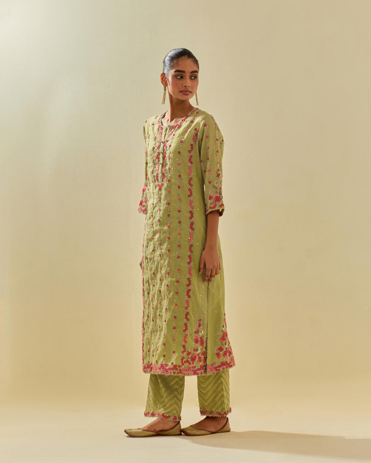 Green tissue chanderi paneled kurta set with front placket neckline and all-over hand cut silk flower embroidery.