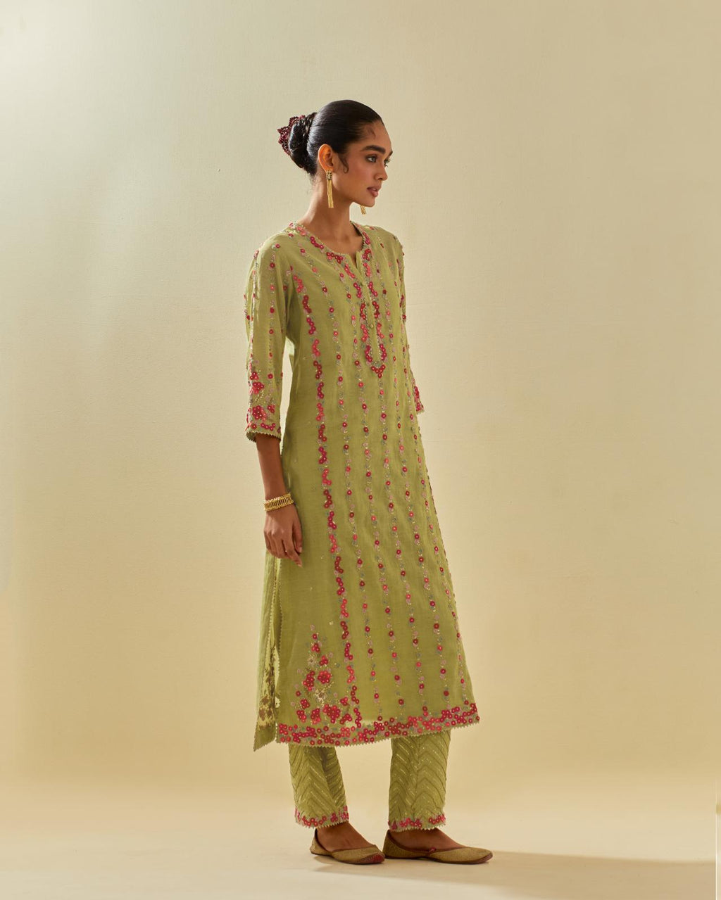 Green tissue chanderi paneled kurta set with front placket neckline and all-over hand cut silk flower embroidery.