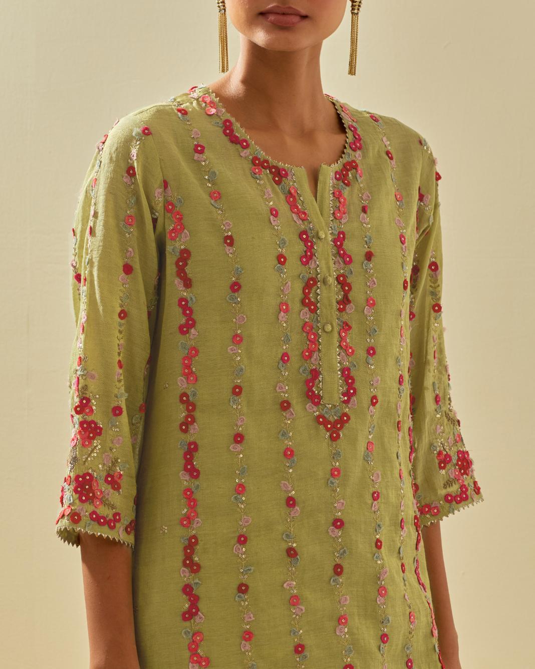 Green tissue chanderi paneled kurta set with front placket neckline and all-over hand cut silk flower embroidery.