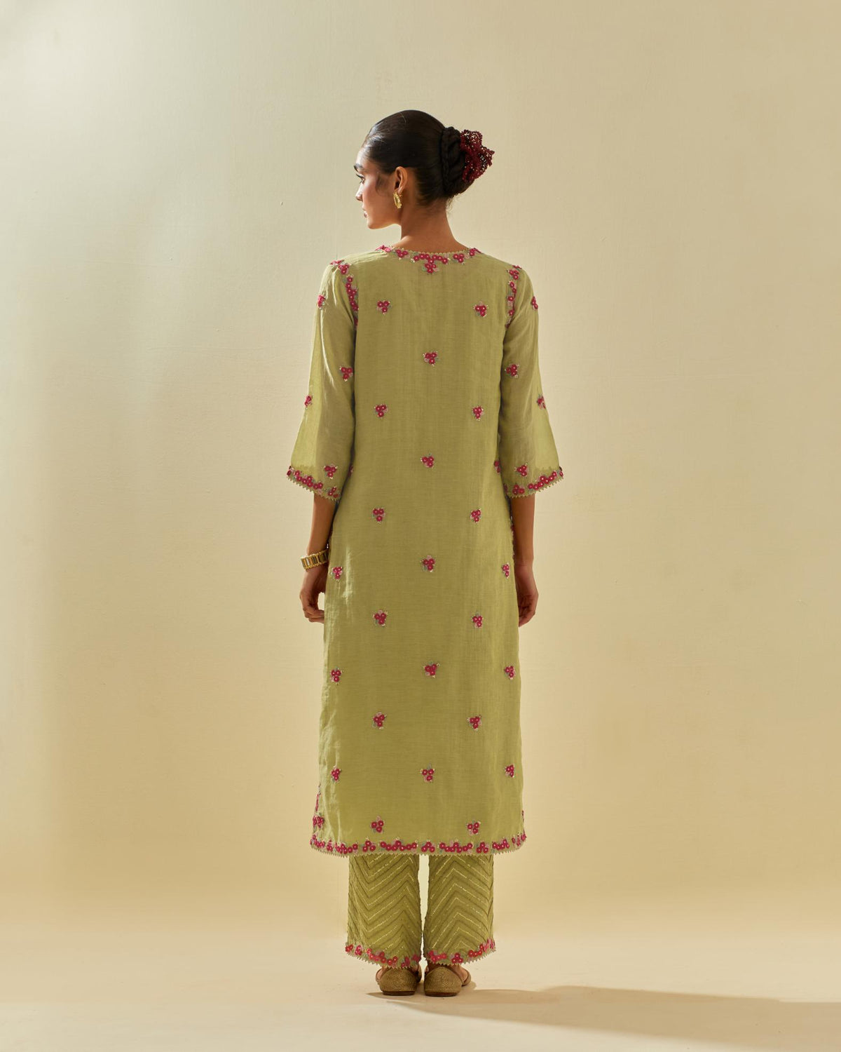 Green tissue chanderi straight kurta set, with contrast silk hand cut flowers embroidery, highlighted with gold sequins.