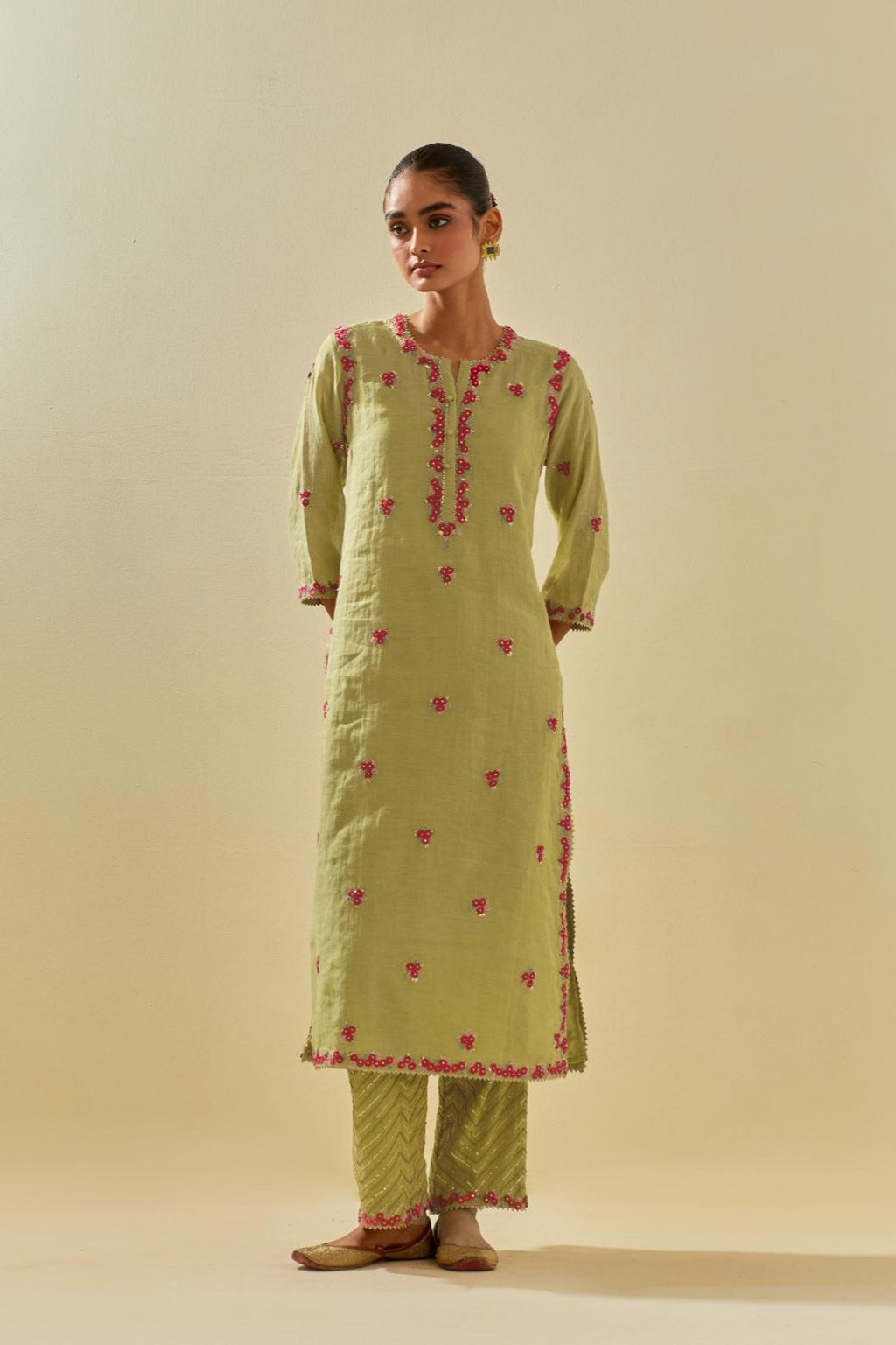 Green tissue chanderi straight kurta set, with contrast silk hand cut flowers embroidery, highlighted with gold sequins.