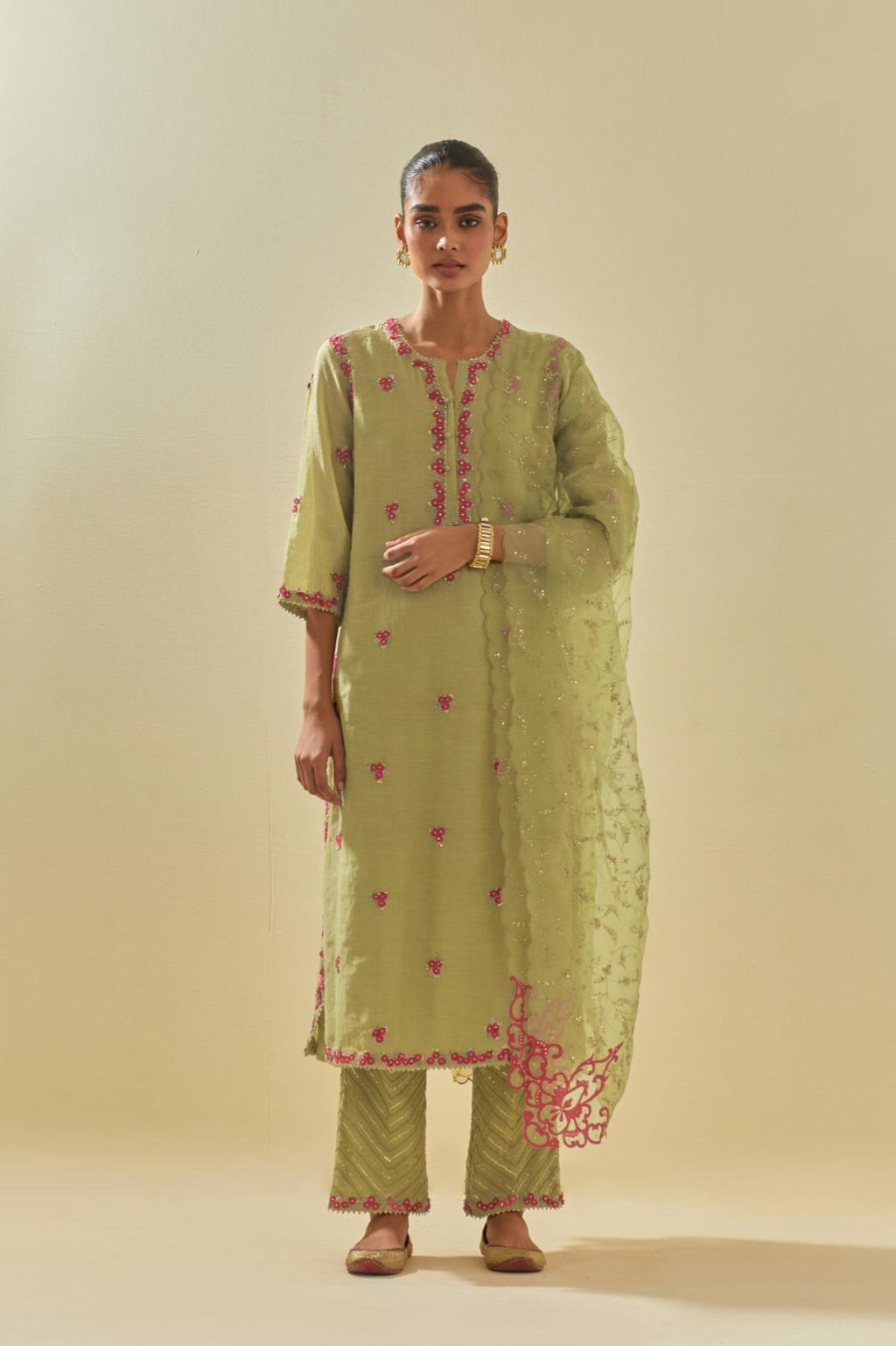 Green tissue chanderi straight kurta set, with contrast silk hand cut flowers embroidery, highlighted with gold sequins.