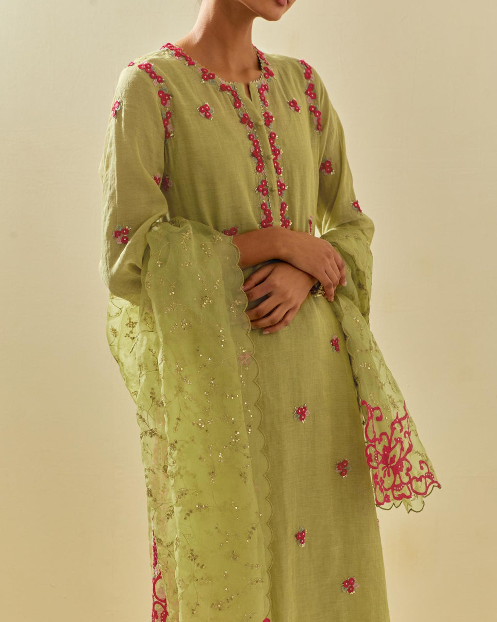 Green tissue chanderi straight kurta set, with contrast silk hand cut flowers embroidery, highlighted with gold sequins.