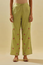 Green tissue chanderi straight pants with hand cut silk flower embroidered booti, highlighted with gold sequins.