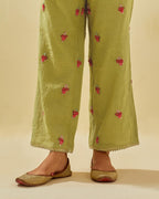 Green tissue chanderi straight pants with hand cut silk flower embroidered booti, highlighted with gold sequins.
