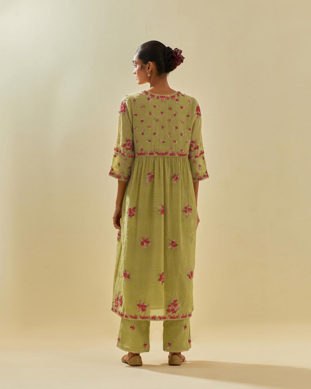 Green tissue chanderi hand cut silk flower embroidered kurta dress set with fine gathers at empire line.
