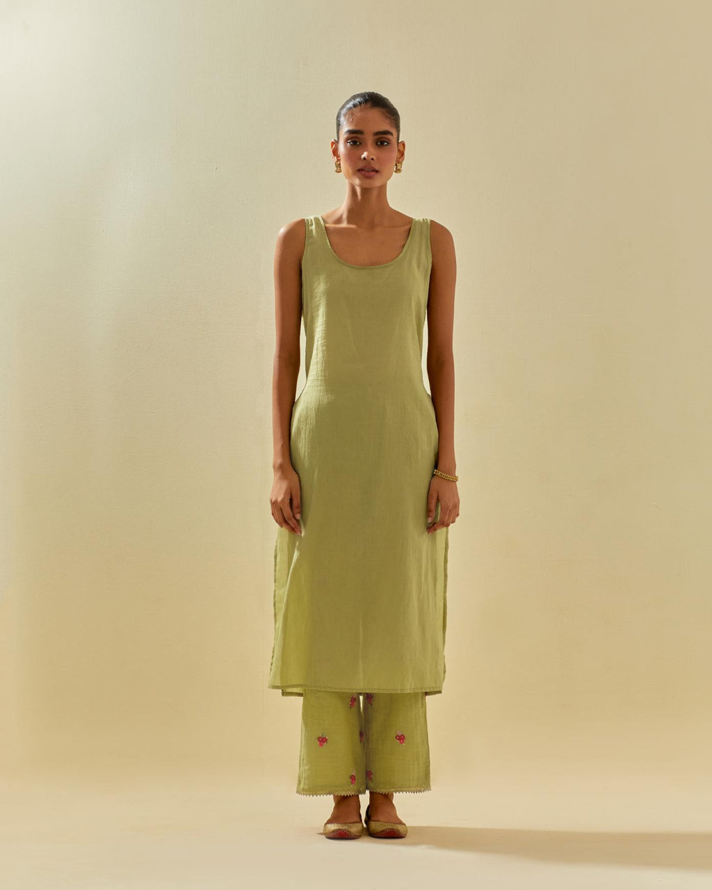 Green tissue chanderi straight kurta set with randomly placed hand cut silk flower bunches, highlighted with gold sequins.