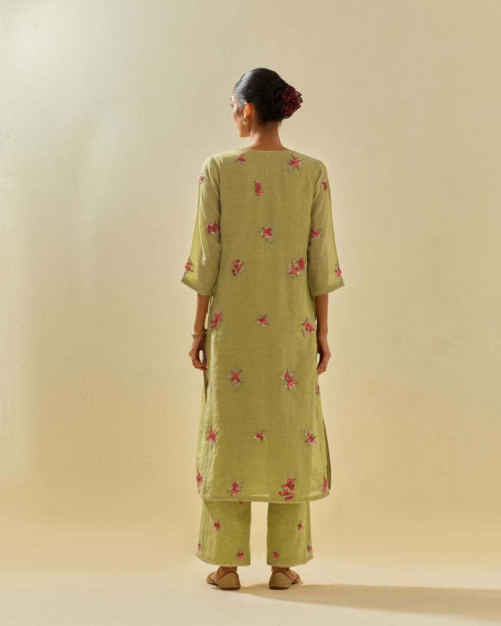 Green tissue chanderi straight kurta set with randomly placed hand cut silk flower bunches, highlighted with gold sequins.