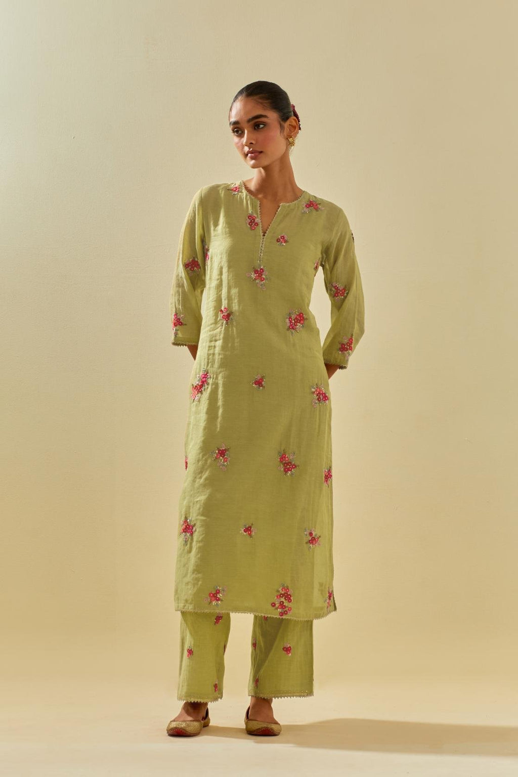 Green tissue chanderi straight kurta set with randomly placed hand cut silk flower bunches, highlighted with gold sequins.