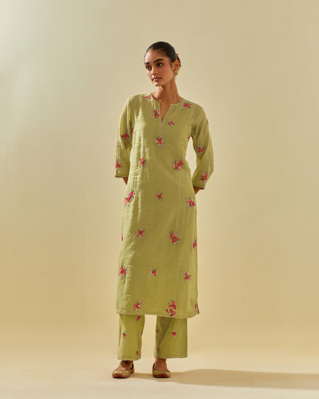 Green tissue chanderi straight kurta set with randomly placed hand cut silk flower bunches, highlighted with gold sequins.