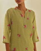 Green tissue chanderi straight kurta set with randomly placed hand cut silk flower bunches, highlighted with gold sequins.