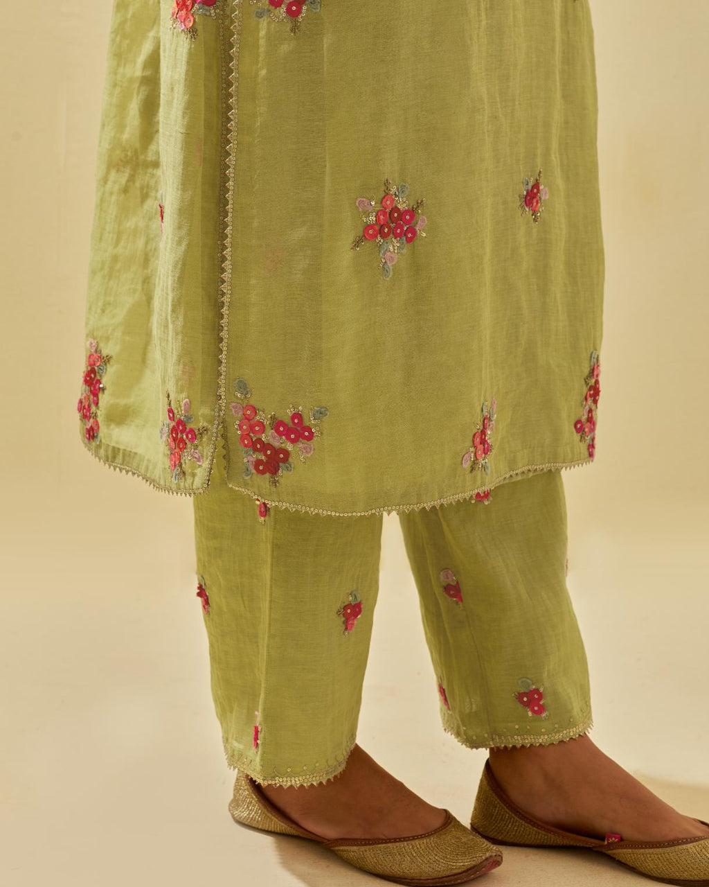 Green tissue chanderi straight kurta set with randomly placed hand cut silk flower bunches, highlighted with gold sequins.