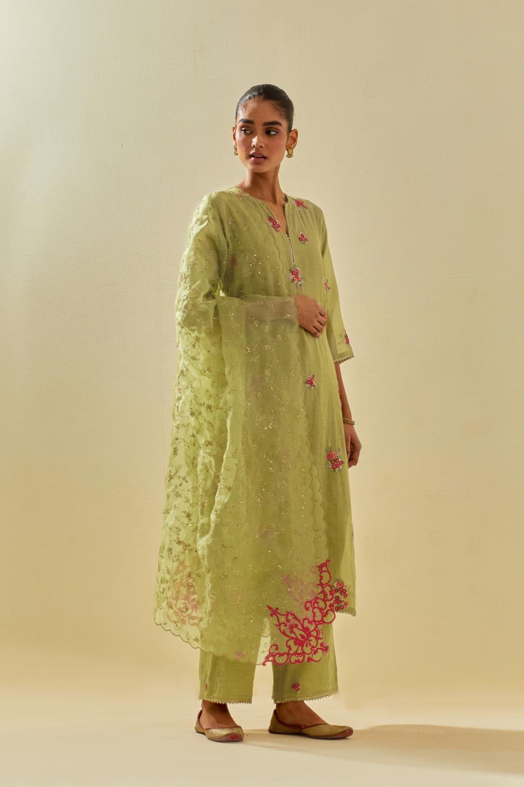 Green tissue chanderi straight kurta set with randomly placed hand cut silk flower bunches, highlighted with gold sequins.