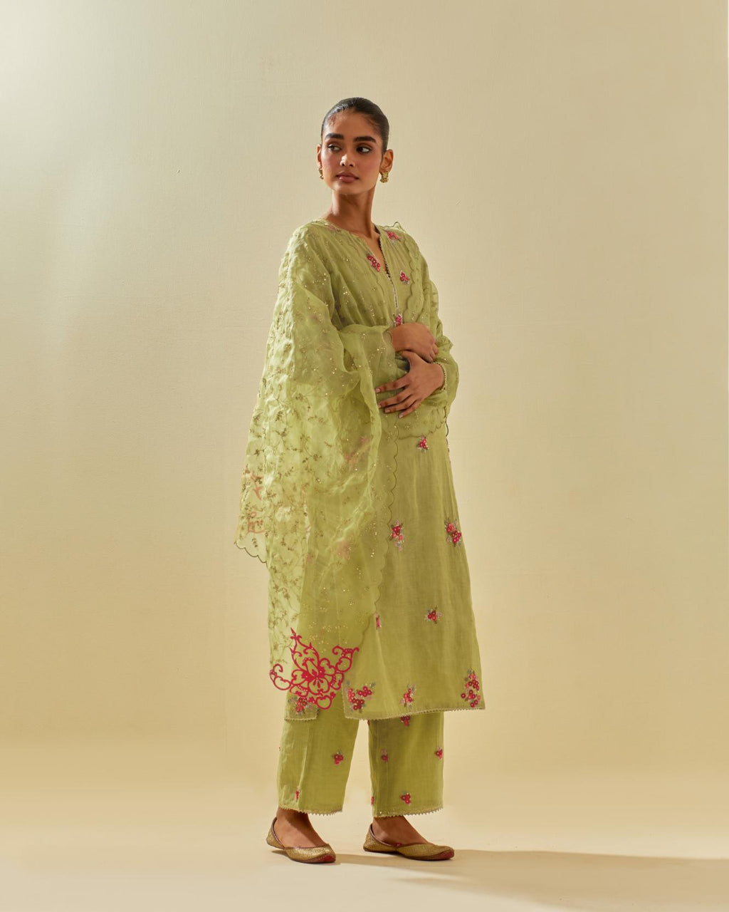 Green tissue chanderi straight kurta set with randomly placed hand cut silk flower bunches, highlighted with gold sequins.