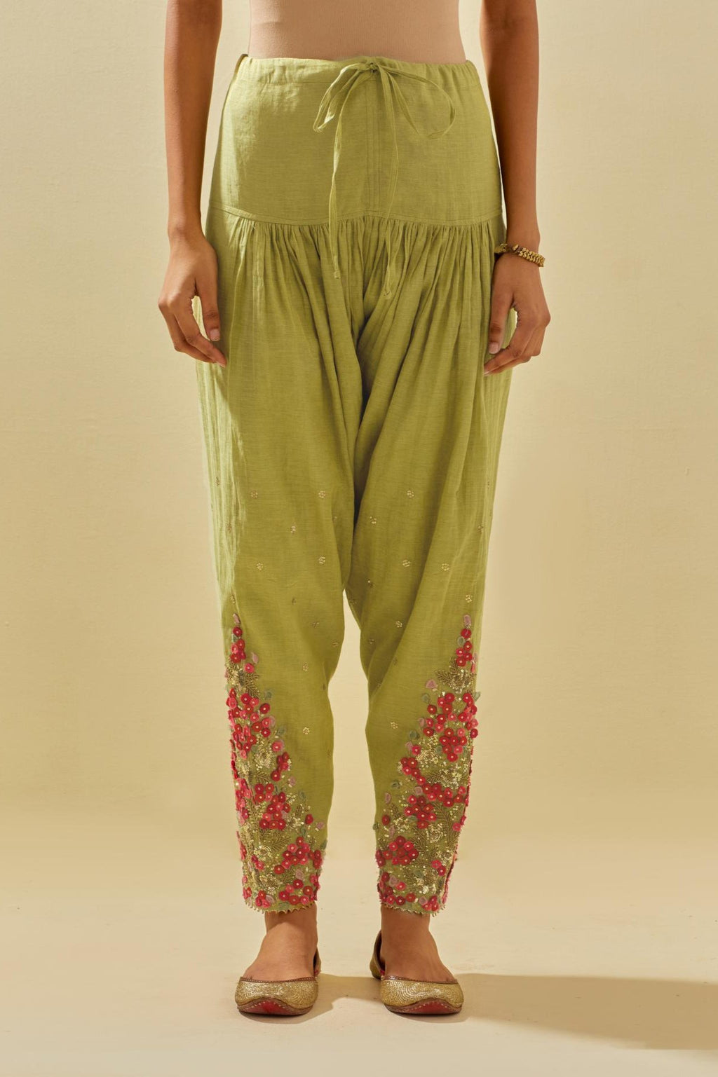 Green tissue chanderi salwar with hand cut silk flower embroidery, highlighted with gold sequins.