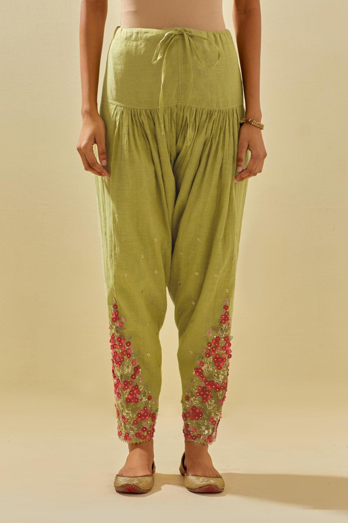 Green tissue chanderi salwar with hand cut silk flower embroidery, highlighted with gold sequins.