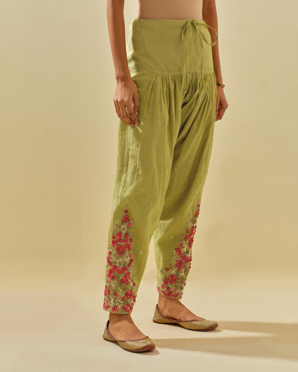 Green tissue chanderi salwar with hand cut silk flower embroidery, highlighted with gold sequins.