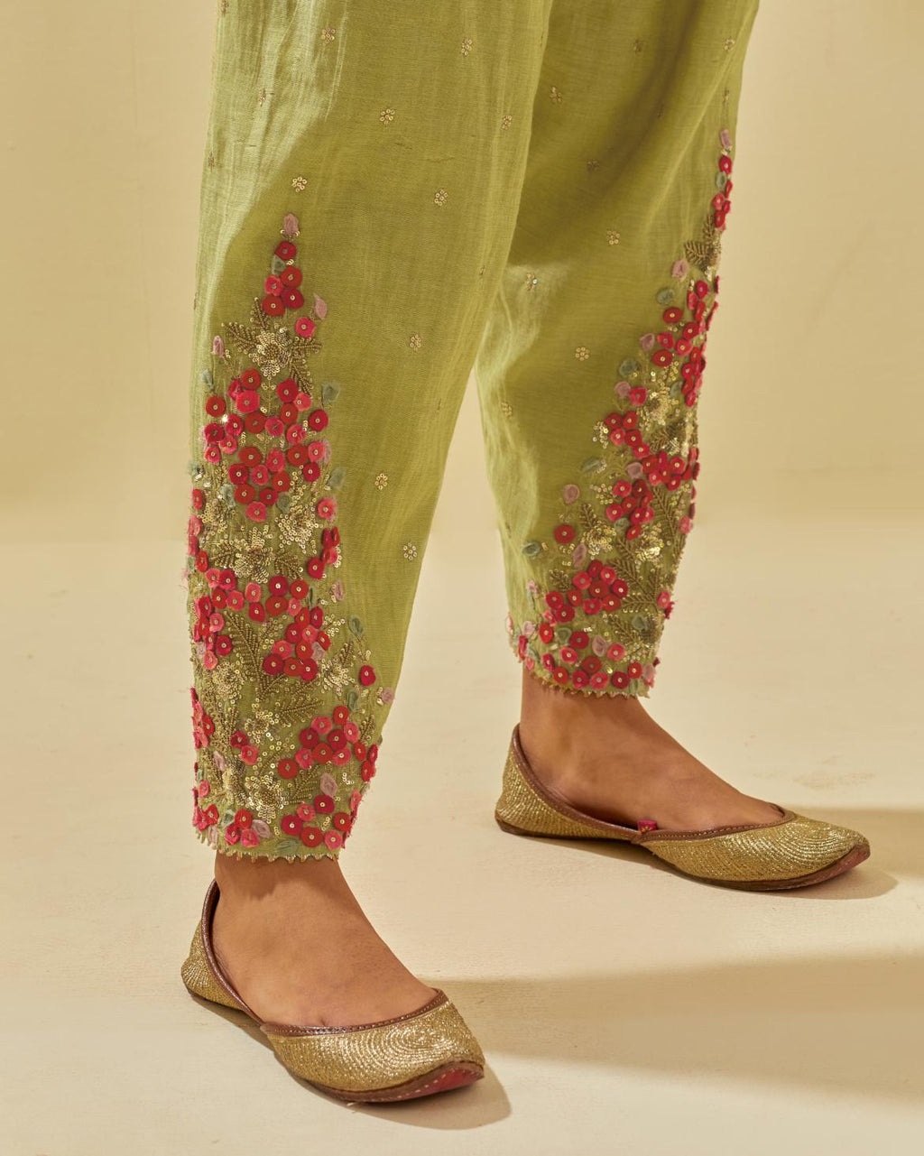 Green tissue chanderi salwar with hand cut silk flower embroidery, highlighted with gold sequins.