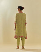 Green tissue chanderi mid length kalidar kurta set with hand cut silk flower embroidery, highlighted with gold sequins.