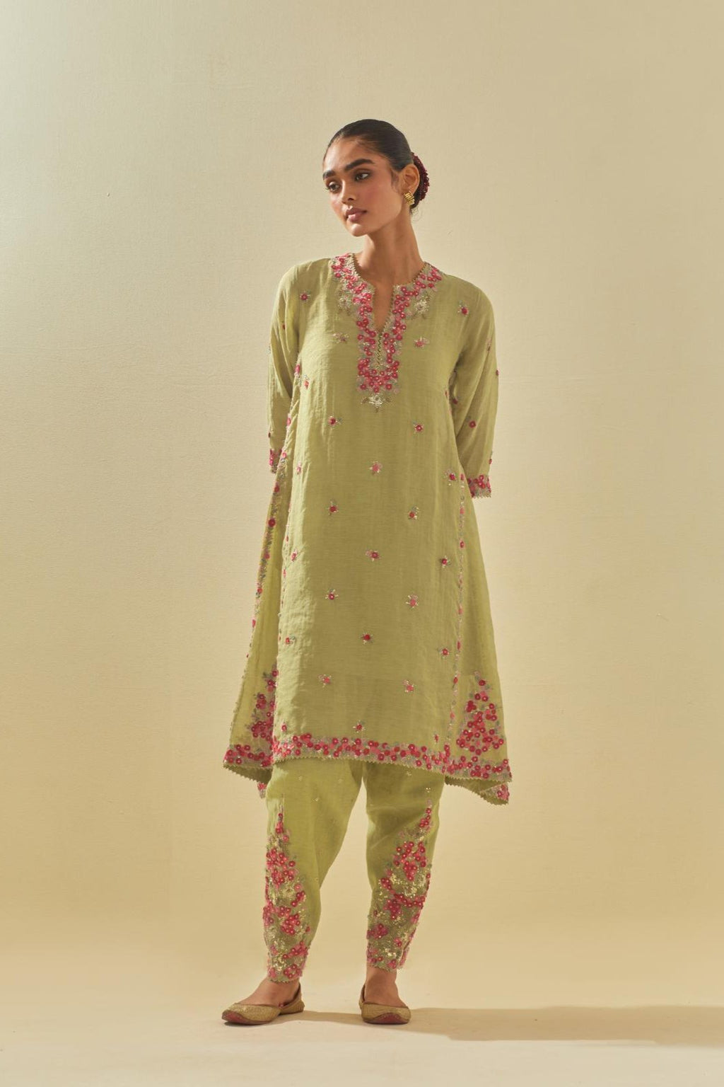 Green tissue chanderi mid length kalidar kurta set with hand cut silk flower embroidery, highlighted with gold sequins.