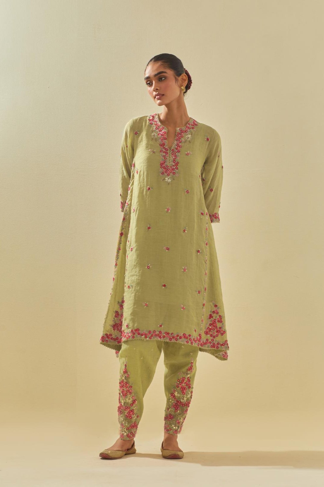 Green tissue chanderi mid length kalidar kurta set with hand cut silk flower embroidery, highlighted with gold sequins.