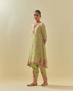 Green tissue chanderi mid length kalidar kurta set with hand cut silk flower embroidery, highlighted with gold sequins.