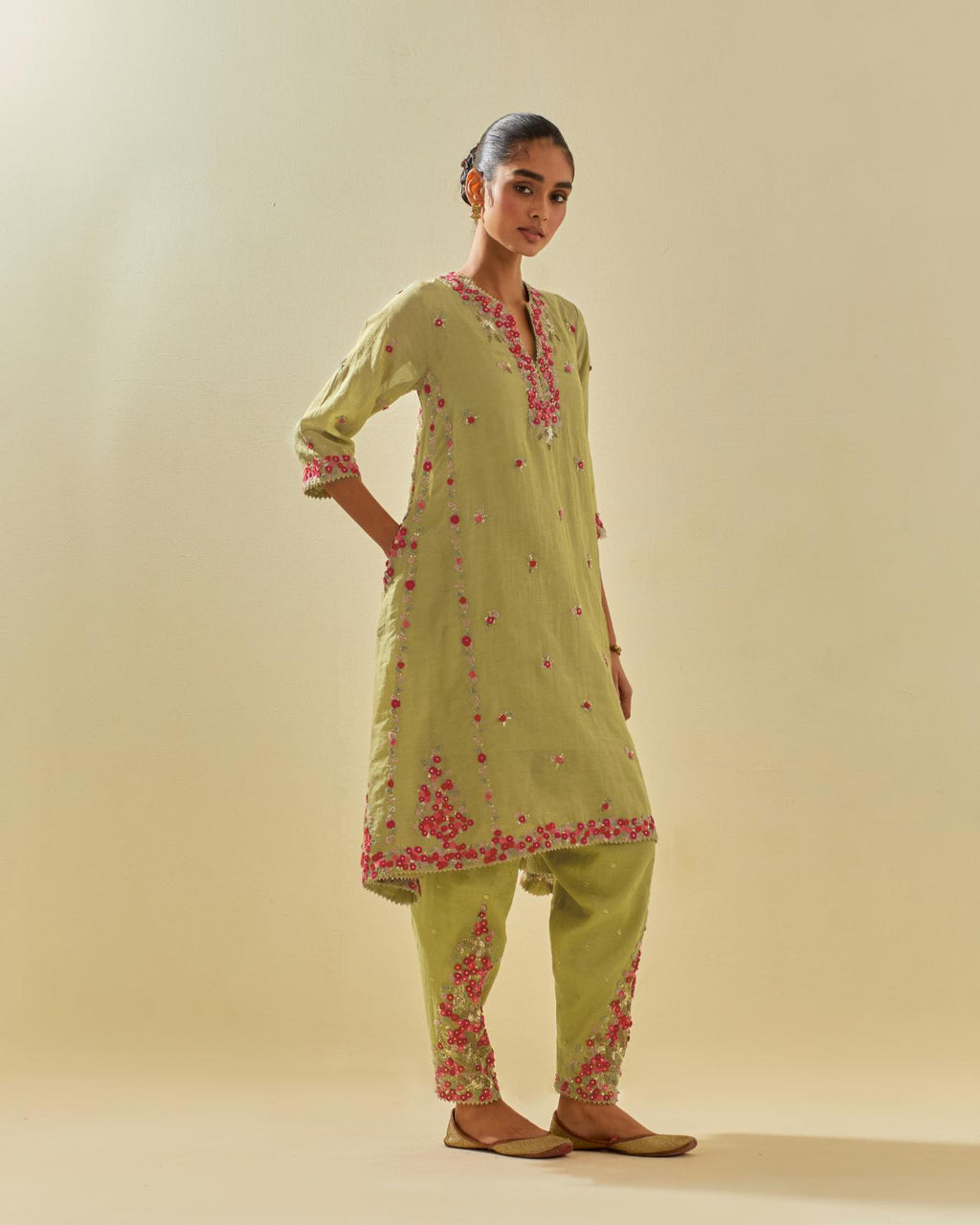 Green tissue chanderi mid length kalidar kurta set with hand cut silk flower embroidery, highlighted with gold sequins.