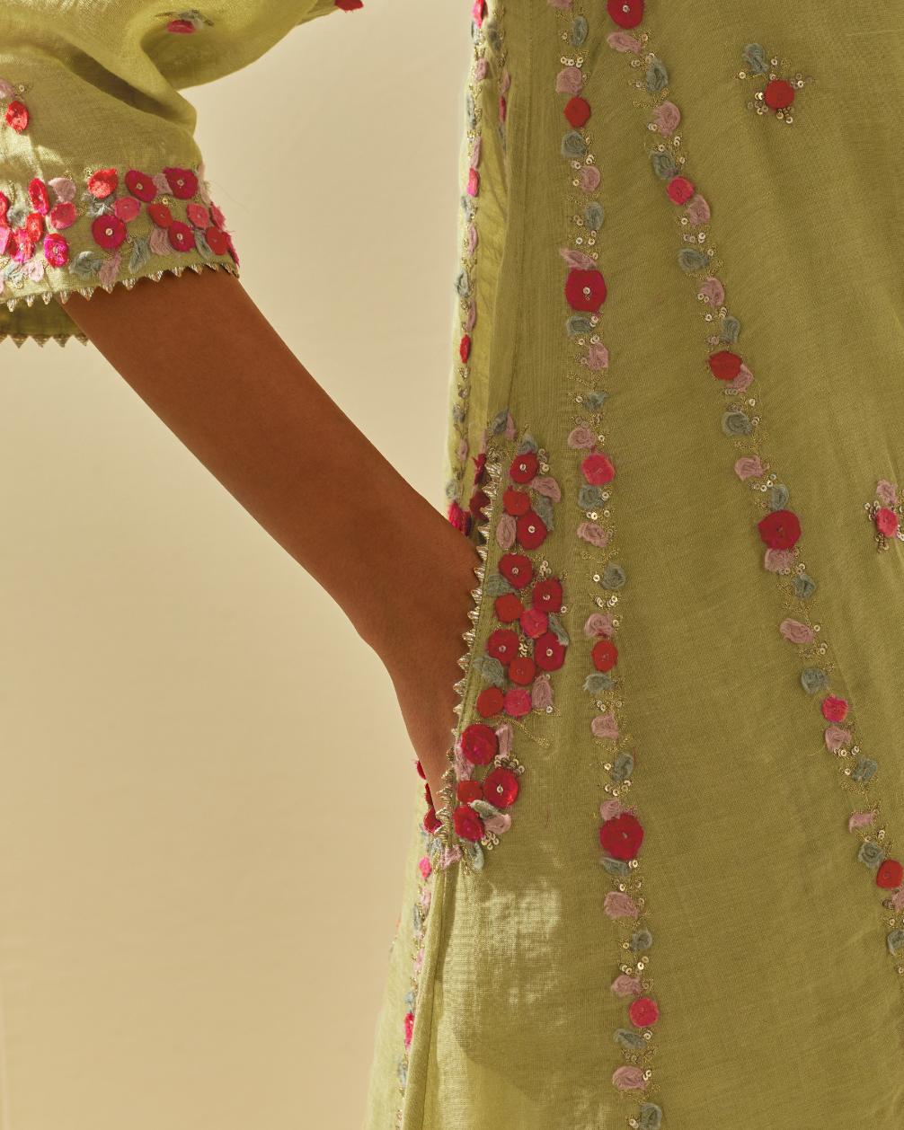 Green tissue chanderi mid length kalidar kurta set with hand cut silk flower embroidery, highlighted with gold sequins.