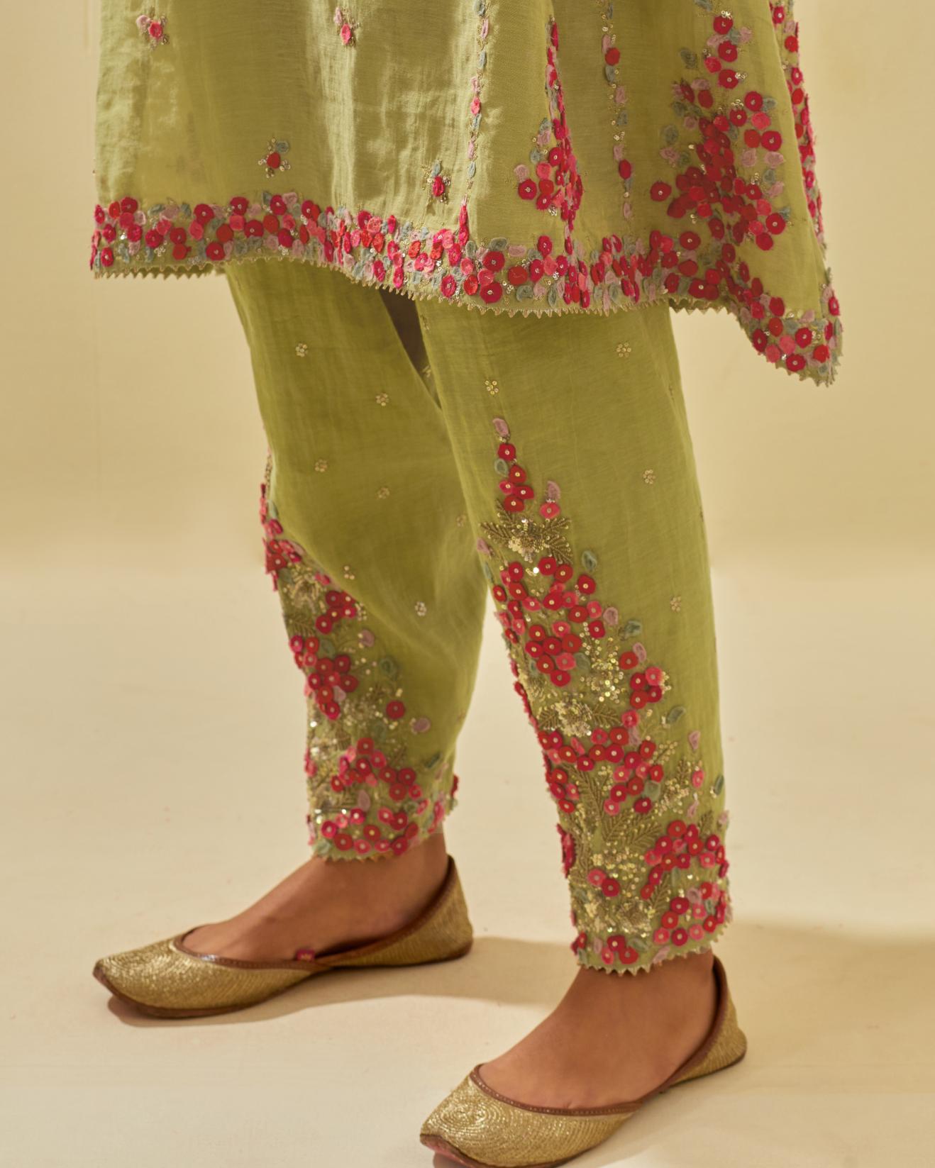 Green tissue chanderi mid length kalidar kurta set with hand cut silk flower embroidery, highlighted with gold sequins.