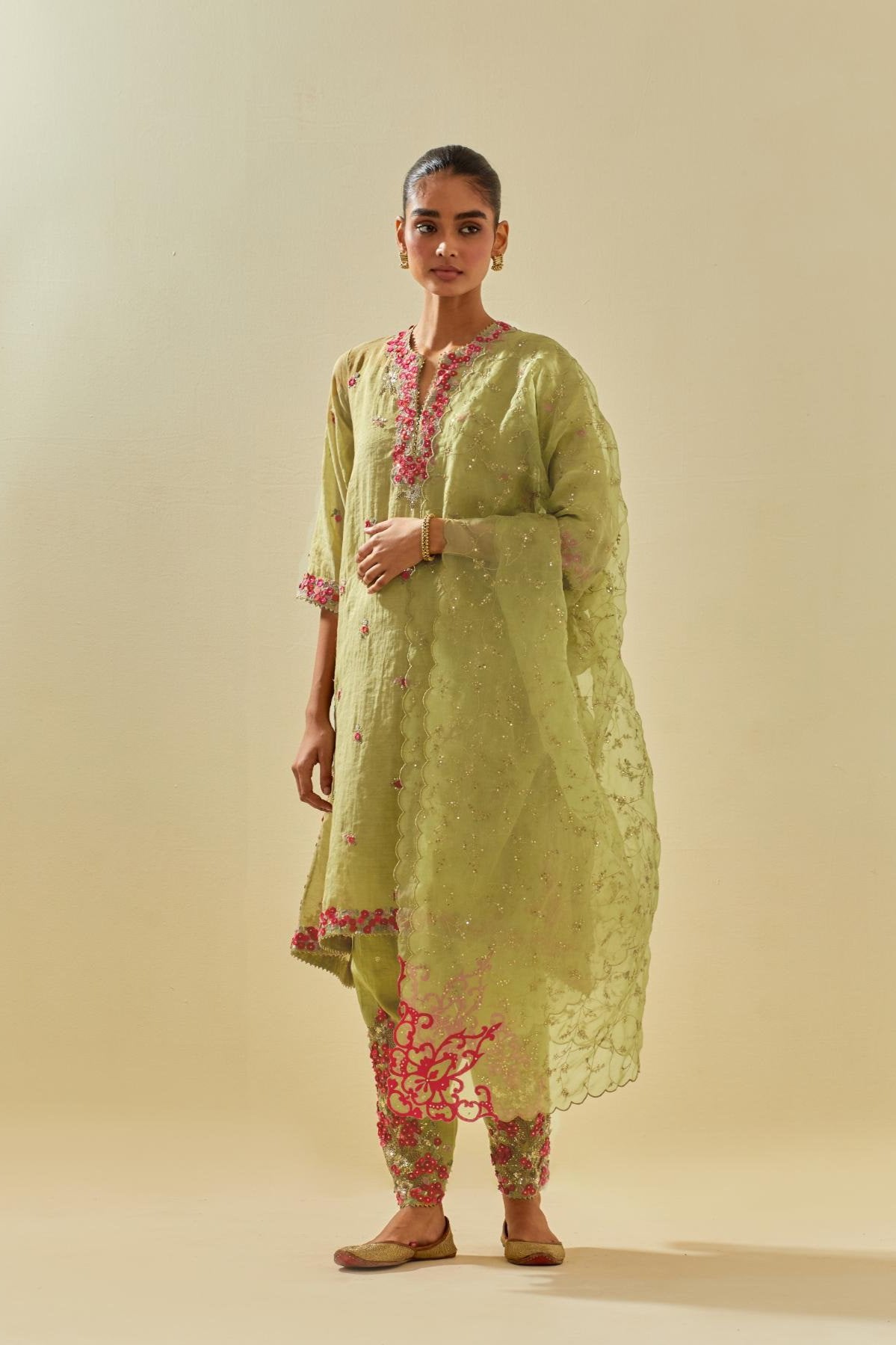 Green tissue chanderi mid length kalidar kurta set with hand cut silk flower embroidery, highlighted with gold sequins.
