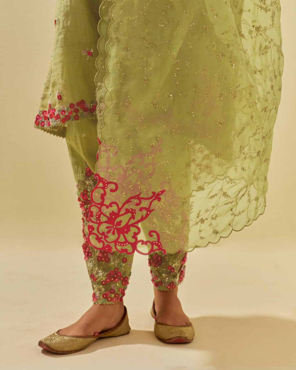 Green tissue chanderi mid length kalidar kurta set with hand cut silk flower embroidery, highlighted with gold sequins.