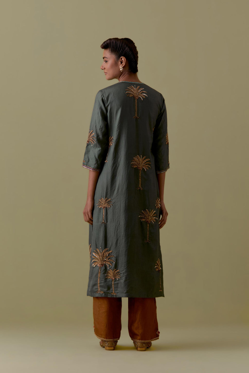 Green silk straight Kurta set with Hand-Worked Palm Motifs.
