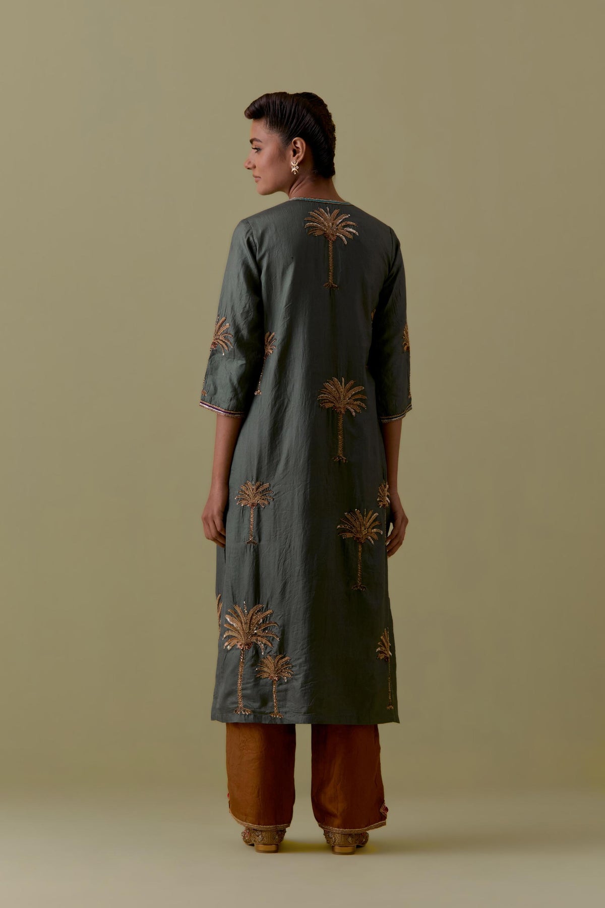 Green silk straight Kurta set with Hand-Worked Palm Motifs.
