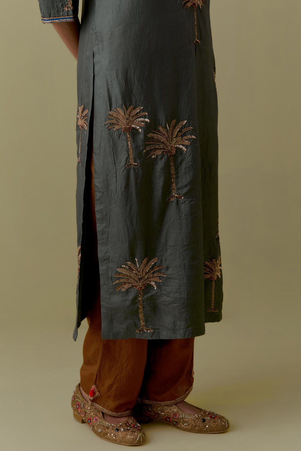 Green silk straight Kurta set with Hand-Worked Palm Motifs.