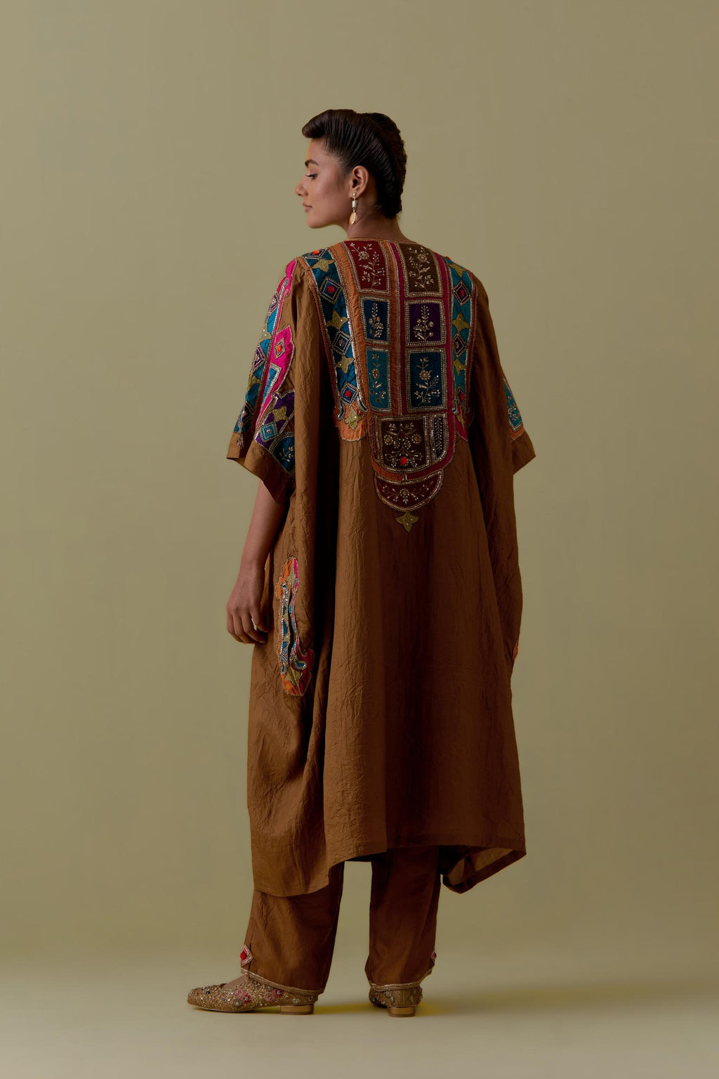 Olive Kaftan with Multicoloured Appliqué & Handwork. Paired with olive Silk Hand-Block Printed Straight Pants with hand work at hem.