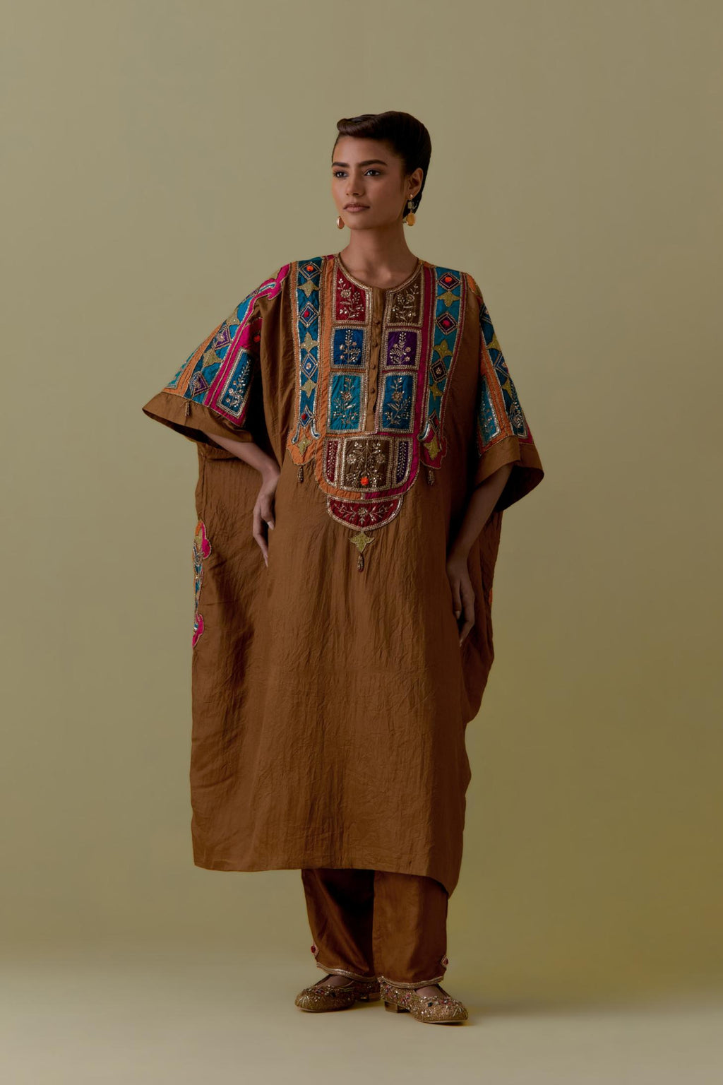 Olive Kaftan with Multicoloured Appliqué & Handwork. Paired with olive Silk Hand-Block Printed Straight Pants with hand work at hem.
